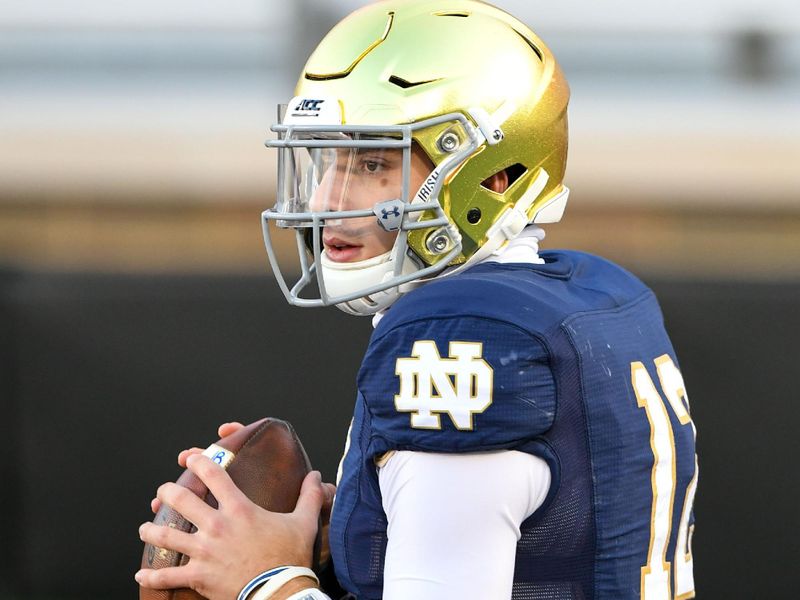 Nov 14, 2020; Chestnut Hill, Massachusetts, USA; Notre Dame Fighting Irish quarterback Ian Book (12) throws the ball during warms ups before a game against the Boston College Eagles at Alumni Stadium. Mandatory Credit: Brian Fluharty-USA TODAY Sports