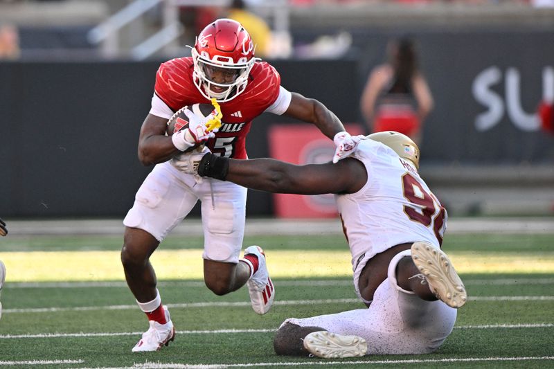 Sep 23, 2023; Louisville, Kentucky, USA;  Louisville Cardinals running back Jawhar Jordan (25) runs the ball against Boston College Eagles defensive tackle Cam Horsley (96) during the second half at L&N Federal Credit Union Stadium. Louisville defeated Boston College 56-28. Mandatory Credit: Jamie Rhodes-USA TODAY Sports