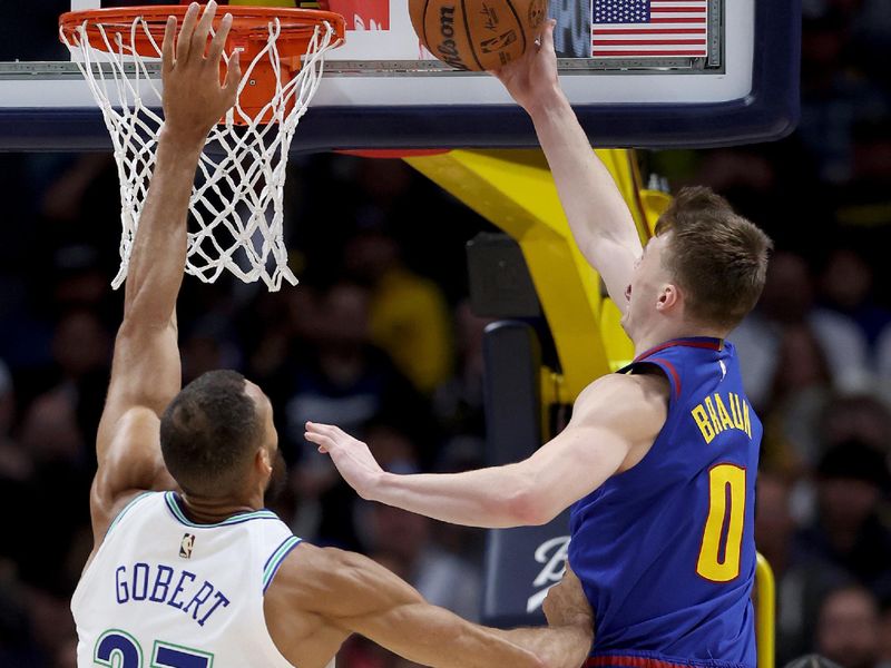 DENVER, COLORADO - MARCH 29: Christian Braun #0 of the Denver Nuggets goes to the basket against 	Rudy Gobert #27 of the Minnesota Timberwolves during the first quarter at Ball Arena on March 29, 2024 in Denver, Colorado. NOTE TO USER: User expressly acknowledges and agrees that, by downloading and or using this photograph, User is consenting to the terms and conditions of the Getty Images License Agreement.  (Photo by Matthew Stockman/Getty Images)