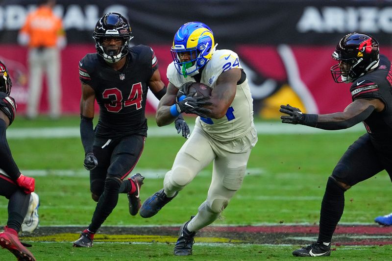 Los Angeles Rams running back Royce Freeman runs with the ball during the first half of an NFL football game against the Arizona Cardinals, Sunday, Nov. 26, 2023, in Glendale, Ariz. (AP Photo/Matt York)