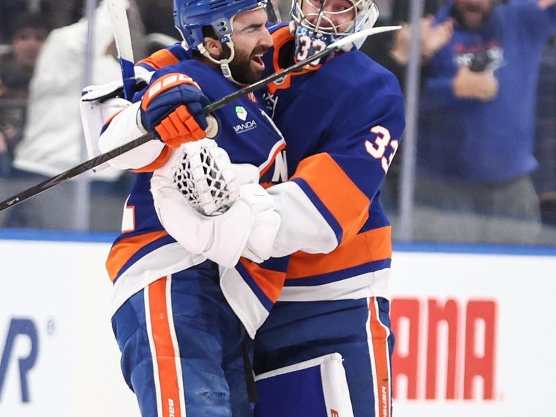 Nov 23, 2025; Elmont, New York, USA;  New York Islanders center Kyle Palmieri (21) celebrates with goaltender David Rittich (33) after scoring the game winning shootout goal in overtime against the Seattle Kraken at UBS Arena. Mandatory Credit: Wendell Cruz-Imagn Images