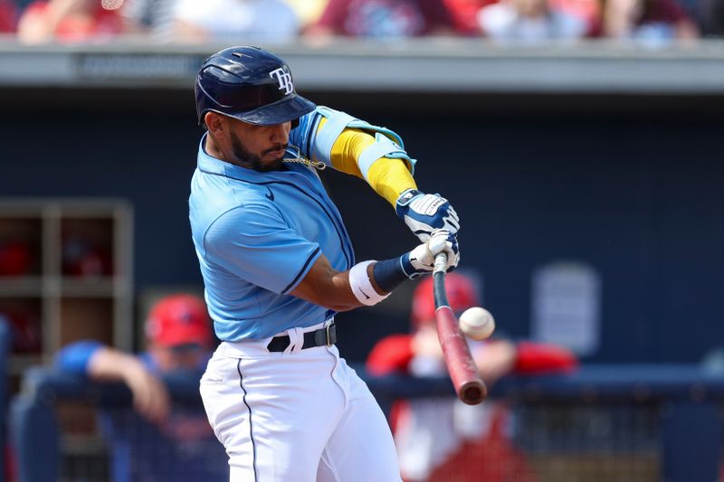 Mar 7, 2024; Port Charlotte, Florida, USA;  Tampa Bay Rays shortstop Jose Caballero (7) hits a base hit against the Philadelphia Phillies in the fifth inning at Charlotte Sports Park. Mandatory Credit: Nathan Ray Seebeck-USA TODAY Sports