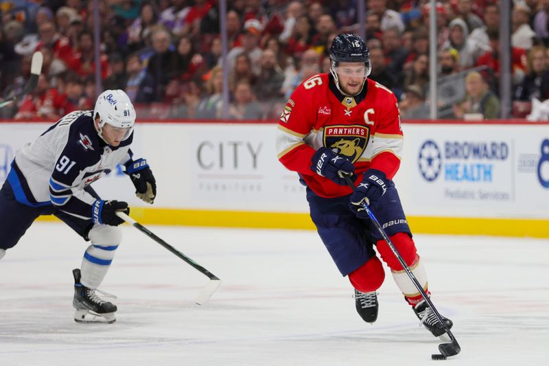 Nov 24, 2023; Sunrise, Florida, USA; Florida Panthers center Aleksander Barkov (16) moves the puck against the Winnipeg Jets during the second period at Amerant Bank Arena. Mandatory Credit: Sam Navarro-USA TODAY Sports