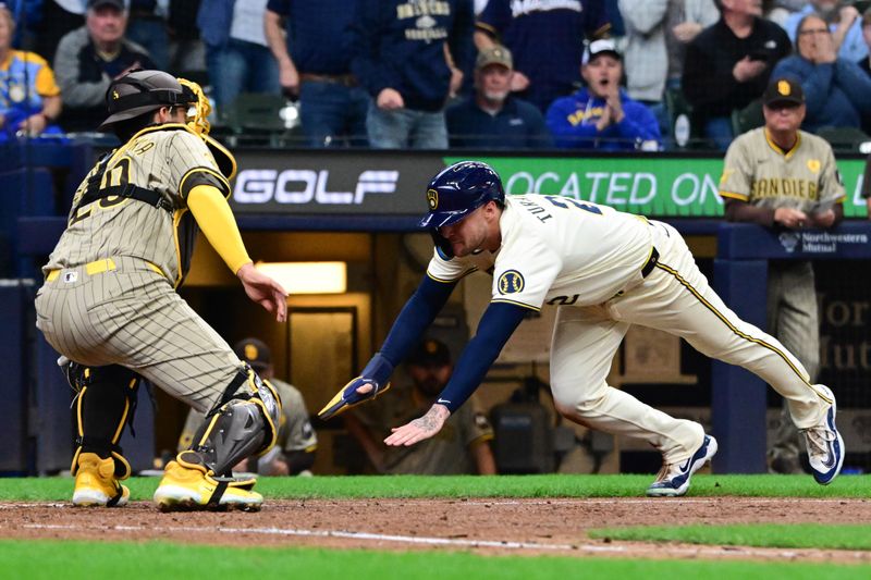 Apr 17, 2024; Milwaukee, Wisconsin, USA; Milwaukee Brewers second baseman Brice Turang (2) scores before tag by San Diego Padres catcher Kyle Higashioka (20) in the eighth inning at American Family Field. Mandatory Credit: Benny Sieu-USA TODAY Sports