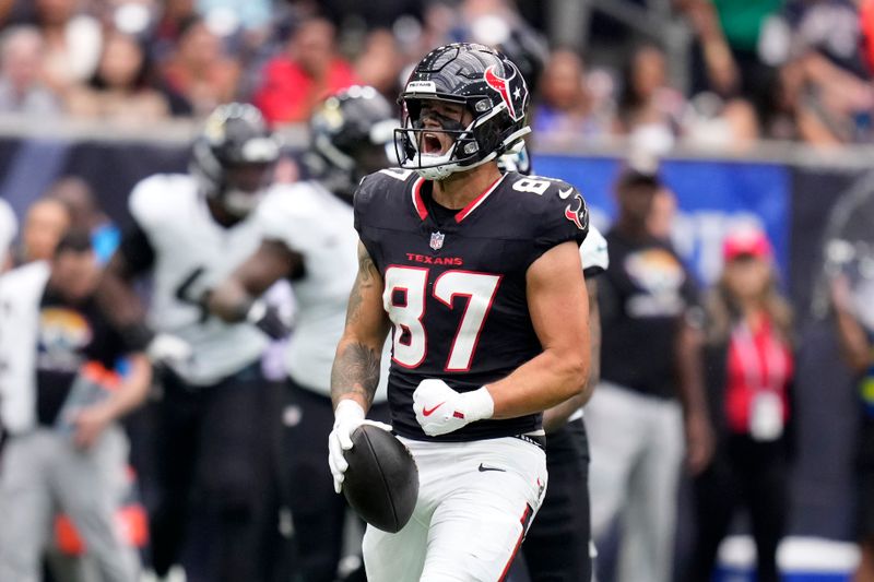 Houston Texans tight end Cade Stover (87) celebrates after catching a pass for a first down during the first half of an NFL football game against the Jacksonville Jaguars, Sunday, Sept. 29, 2024, in Houston. (AP Photo/Eric Christian Smith)