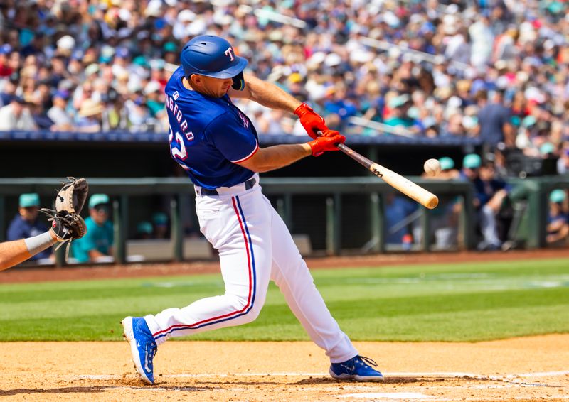 Mar 18, 2024; Surprise, Arizona, USA; Texas Rangers outfielder Wyatt Langford against the Seattle Mariners during a spring training baseball game at Surprise Stadium. Mandatory Credit: Mark J. Rebilas-USA TODAY Sports