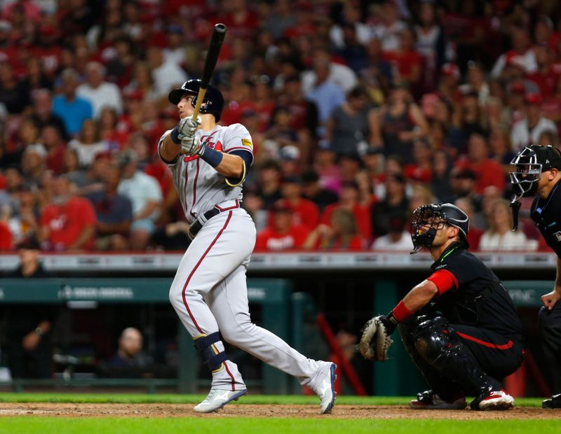 Jun 23, 2023; Cincinnati, Ohio, USA; Atlanta Braves third baseman Austin Riley (27) hits a solo home run against the Cincinnati Reds during the eight inning at Great American Ball Park. Mandatory Credit: David Kohl-USA TODAY Sports