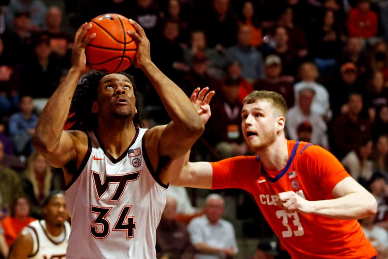 Jan 10, 2024; Blacksburg, Virginia, USA; Virginia Tech Hokies forward Mylyjael Poteat (34) drives to the basket against Clemson Tigers forward Bas Leyte (33) during the second half at Cassell Coliseum. Mandatory Credit: Peter Casey-USA TODAY Sports