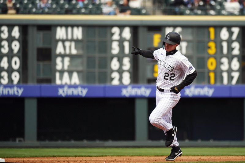 Apr 19, 2025; Denver, Colorado, USA; Colorado Rockies outfielder Mickey Moniak (22) runs the bases after a home run during the second inning against the Washington Nationals at Coors Field. Mandatory Credit: Christopher Hanewinckel-Imagn Images