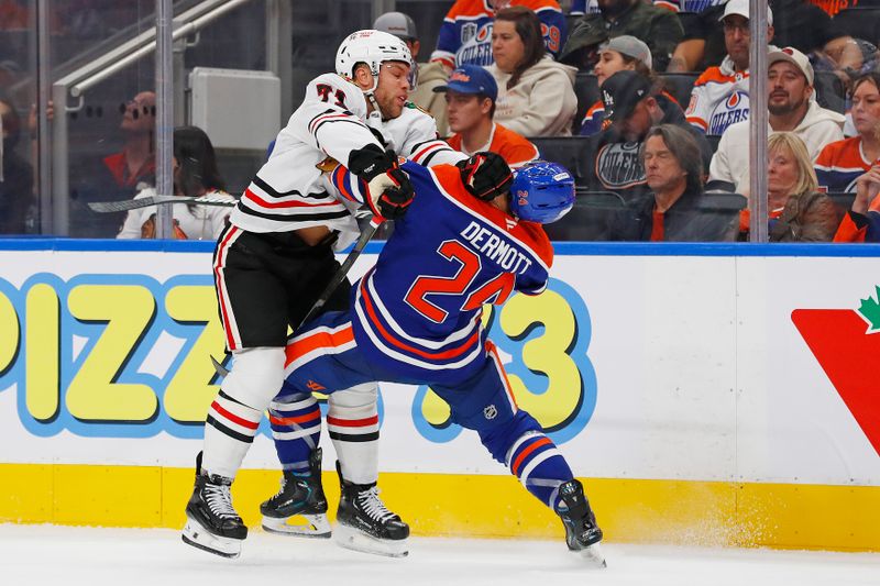 Oct 12, 2024; Edmonton, Alberta, CAN; Chicago Blackhawks forward Taylor Hall (71) checks Edmonton Oilers defensemen Travis Dermott (24) during the second period at Rogers Place. Mandatory Credit: Perry Nelson-Imagn Images