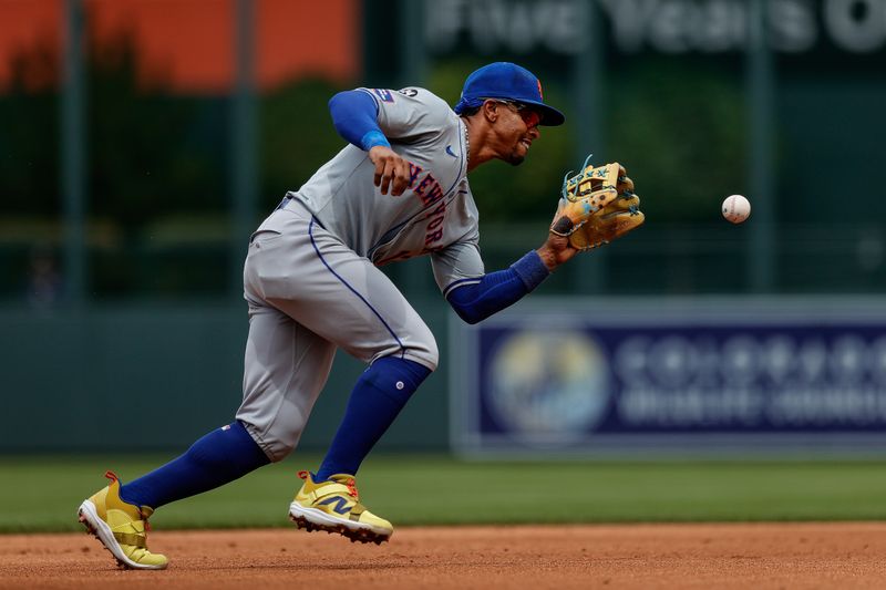 Aug 8, 2024; Denver, Colorado, USA; New York Mets shortstop Francisco Lindor (12) fields the ball in the fourth inning against the Colorado Rockies at Coors Field. Mandatory Credit: Isaiah J. Downing-USA TODAY Sports