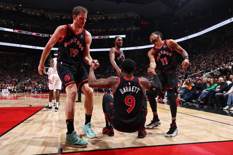 TORONTO, CANADA - FEBRUARY 10: Jakob Poeltl #19 and Bruce Brown #11 of the Toronto Raptors help up RJ Barrett #9 of the Toronto Raptors during the game against the Cleveland Cavaliers on February 10, 2024 at the Scotiabank Arena in Toronto, Ontario, Canada.  NOTE TO USER: User expressly acknowledges and agrees that, by downloading and or using this Photograph, user is consenting to the terms and conditions of the Getty Images License Agreement.  Mandatory Copyright Notice: Copyright 2024 NBAE (Photo by Vaughn Ridley/NBAE via Getty Images)