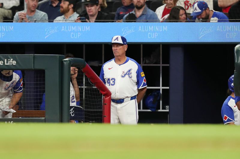 Apr 20, 2024; Cumberland, Georgia, USA;  Atlanta Braves manager Brian Snitker (43) watches from the dugout against the Texas Rangers in the eight inning at Truist Park. Mandatory Credit: Mady Mertens-USA TODAY Sports