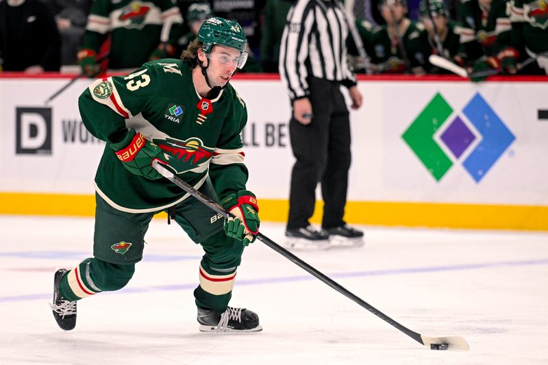 Jan 22, 2026; Saint Paul, Minnesota, USA;  Minnesota Wild defensemen Quinn Hughes (43) controls the puck against the Detroit Red Wings during the second period at Grand Casino Arena. Mandatory Credit: Nick Wosika-Imagn Images