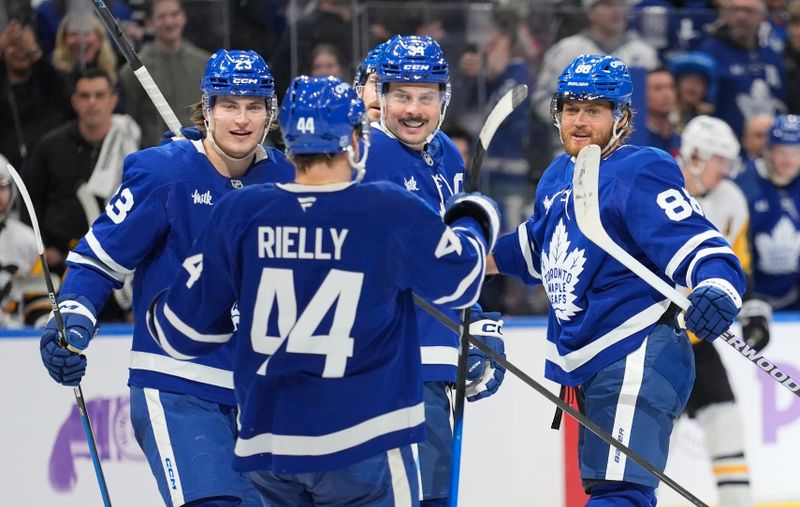 Nov 3, 2025; Toronto, Ontario, CAN; Toronto Maple Leafs defenseman Morgan Rielly (44), forward Matthew Knies (23) and forward Auston Matthews (34) congratulate forward William Nylander (88) after his second goal of the third period against the Pittsburgh Penguins at Scotiabank Arena. Mandatory Credit: John E. Sokolowski-Imagn Images