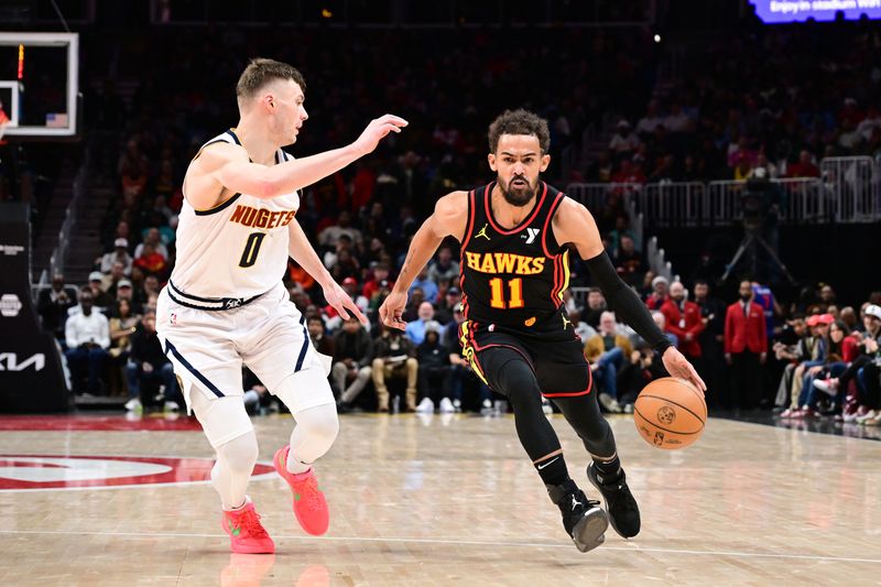 ATLANTA, GA - DECEMBER 8: Trae Young #11 of the Atlanta Hawks dribbles the ball during the game against the Denver Nuggets on December 8, 2024 at State Farm Arena in Atlanta, Georgia.  NOTE TO USER: User expressly acknowledges and agrees that, by downloading and/or using this Photograph, user is consenting to the terms and conditions of the Getty Images License Agreement. Mandatory Copyright Notice: Copyright 2024 NBAE (Photo by Adam Hagy/NBAE via Getty Images)