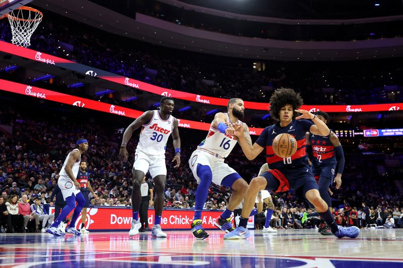 PHILADELPHIA, PENNSYLVANIA - JANUARY 08: Kyshawn George #18 of the Washington Wizards dribbles the ball against Caleb Martin #16 of the Philadelphia 76ers during a game at the Wells Fargo Center on January 08, 2025 in Philadelphia, Pennsylvania. NOTE TO USER: User expressly acknowledges and agrees that, by downloading and or using this photograph, User is consenting to the terms and conditions of the Getty Images License Agreement. (Photo by Emilee Chinn/Getty Images)