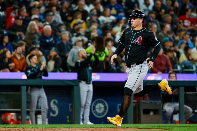 Apr 28, 2024; Seattle, Washington, USA; Arizona Diamondbacks designated hitter Joc Pederson (3) scores a run against the Seattle Mariners during the seventh inning at T-Mobile Park. Mandatory Credit: Joe Nicholson-USA TODAY Sports