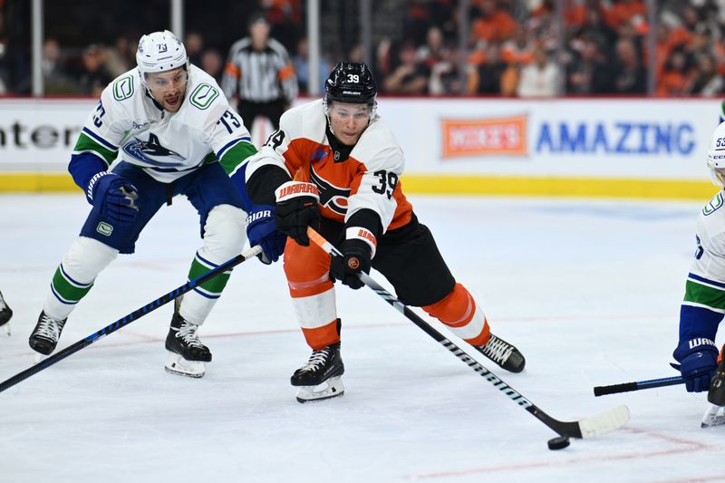 Oct 19, 2024; Philadelphia, Pennsylvania, USA; Philadelphia Flyers right wing Matvei Michkov (39) reaches for the puck against Vancouver Canucks defenseman Vincent Desharnais (73) in the second period at Wells Fargo Center. Mandatory Credit: Kyle Ross-Imagn Images