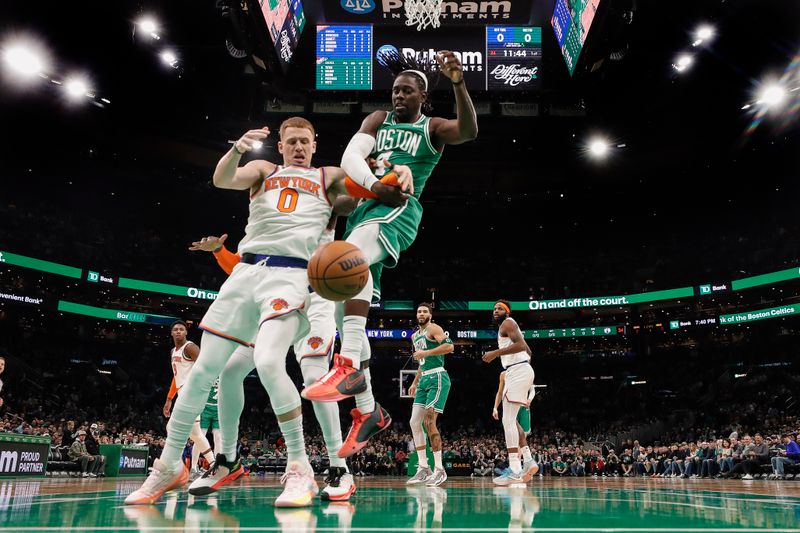 BOSTON, MA - DECEMBER 8: Donte DiVincenzo #0 of the New York Knicks and Jrue Holiday #4 of the Boston Celtics battle for the ball during the second quarter at TD Garden on December 8, 2023 in Boston, Massachusetts. NOTE TO USER: User expressly acknowledges and agrees that, by downloading and/or using this Photograph, user is consenting to the terms and conditions of the Getty Images License Agreement. (Photo By Winslow Townson/Getty Images)