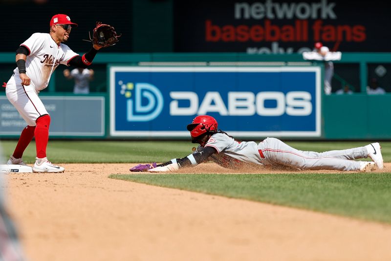 Jul 21, 2024; Washington, District of Columbia, USA; Cincinnati Reds shortstop Elly De La Cruz (44) steals second base ahead of a throw to Washington Nationals second base Ildemaro Vargas (14) during the eighth inning at Nationals Park. Mandatory Credit: Geoff Burke-USA TODAY Sports