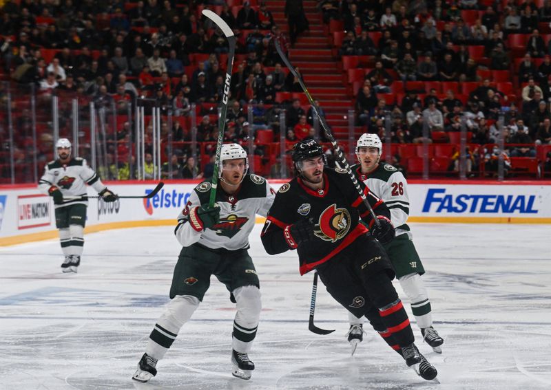 Nov 18, 2023; Stockholm, SWE; Ottawa Senators center Zack MacEwen (17) skates ahead of Minnesota Wild defenseman Jonas Brodin (25) and Minnesota Wild center Connor Dewar (26) during a Global Series NHL hockey game at Avicii Arena. Mandatory Credit: Per Haljestam-USA TODAY Sports