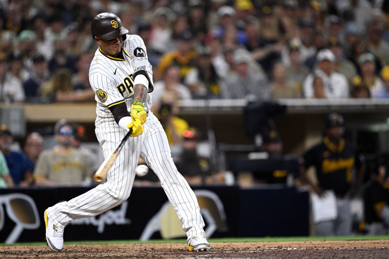 Aug 13, 2024; San Diego, California, USA; San Diego Padres third baseman Manny Machado (13) hits an RBI single against the Pittsburgh Pirates during the eighth inning at Petco Park. Mandatory Credit: Orlando Ramirez-USA TODAY Sports