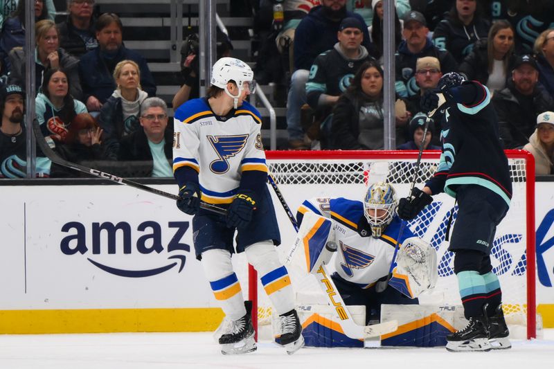 Jan 26, 2024; Seattle, Washington, USA; St. Louis Blues goaltender Jordan Binnington (50) blocks a goal shot by the Seattle Kraken during the third period at Climate Pledge Arena. Mandatory Credit: Steven Bisig-USA TODAY Sports