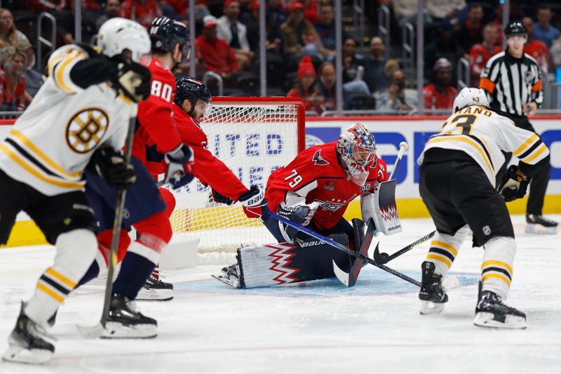 Oct 5, 2024; Washington, District of Columbia, USA; Washington Capitals goaltender Charlie Lindgren (79) makes a save on Boston Bruins left wing Brad Marchand (63) in the second period at Capital One Arena. Mandatory Credit: Geoff Burke-Imagn Images