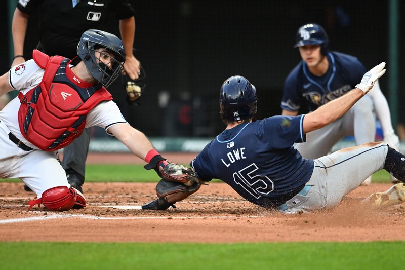 Sep 14, 2024; Cleveland, Ohio, USA; Cleveland Guardians catcher Austin Hedges (27) tags out Tampa Bay Rays left fielder Josh Lowe (15) during the fifth inning at Progressive Field. Mandatory Credit: Ken Blaze-Imagn Images