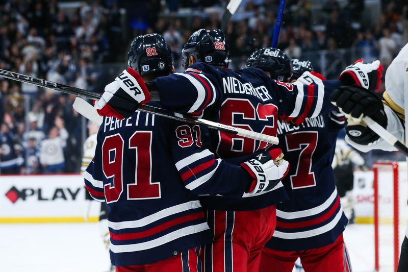 Dec 22, 2023; Winnipeg, Manitoba, CAN;  Winnipeg Jets forward Nino Niederreiter (62) is congratulated by his team mates on his goal against the Boston Bruins during the second period at Canada Life Centre. Mandatory Credit: Terrence Lee-USA TODAY Sports