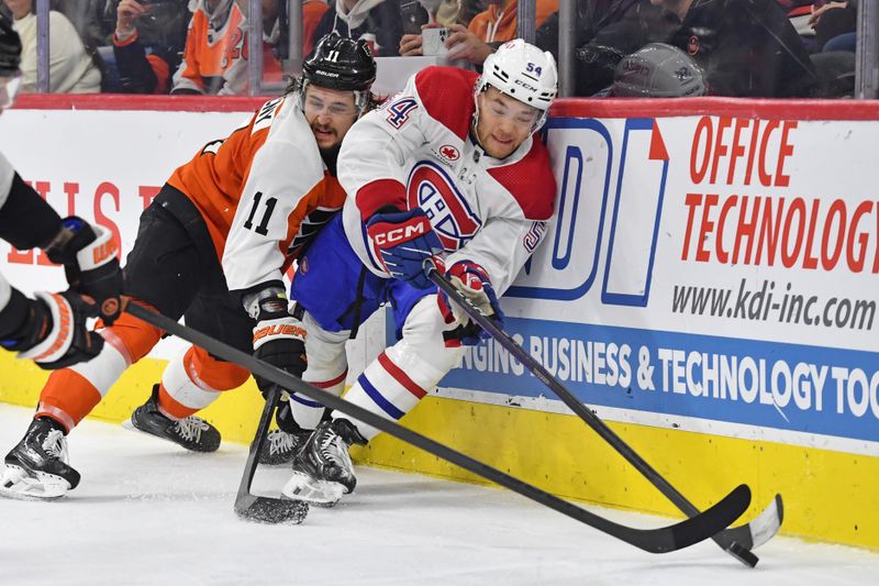 Jan 10, 2024; Philadelphia, Pennsylvania, USA; Philadelphia Flyers center Sean Couturier (14) and Montreal Canadiens defenseman Jordan Harris (54) battle for the puck during third period at Wells Fargo Center. Mandatory Credit: Eric Hartline-USA TODAY Sports