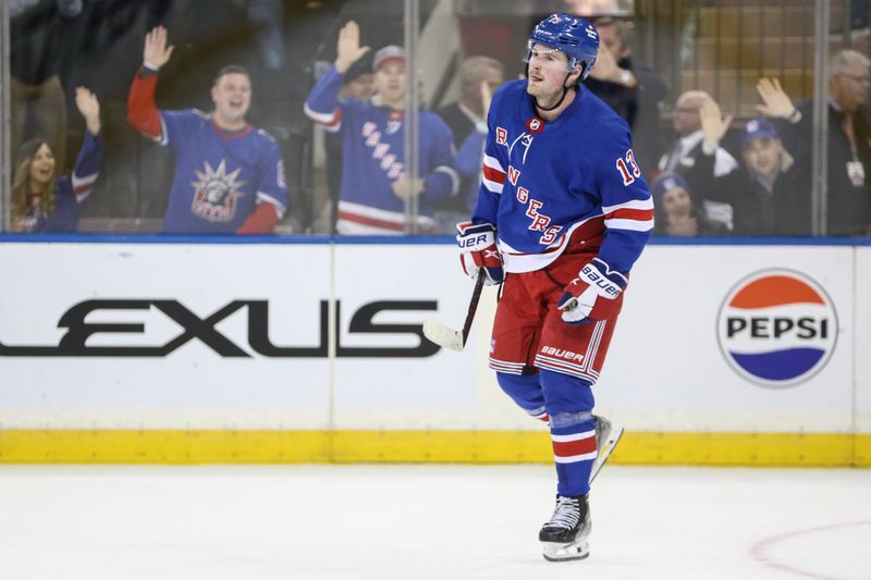 Nov 12, 2023; New York, New York, USA; New York Rangers left wing Alexis Lafreniere (13) scores the game winning goal in a shootout against the Columbus Blue Jackets at Madison Square Garden. Mandatory Credit: Wendell Cruz-USA TODAY Sports