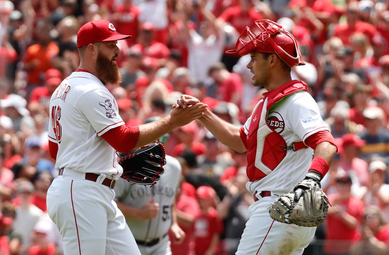 Jun 21, 2023; Cincinnati, Ohio, USA; Cincinnati Reds relief pitcher Buck Farmer (left) reacts with catcher Luke Maile (right) after the Reds defeated the Colorado Rockies at Great American Ball Park. Mandatory Credit: David Kohl-USA TODAY Sports