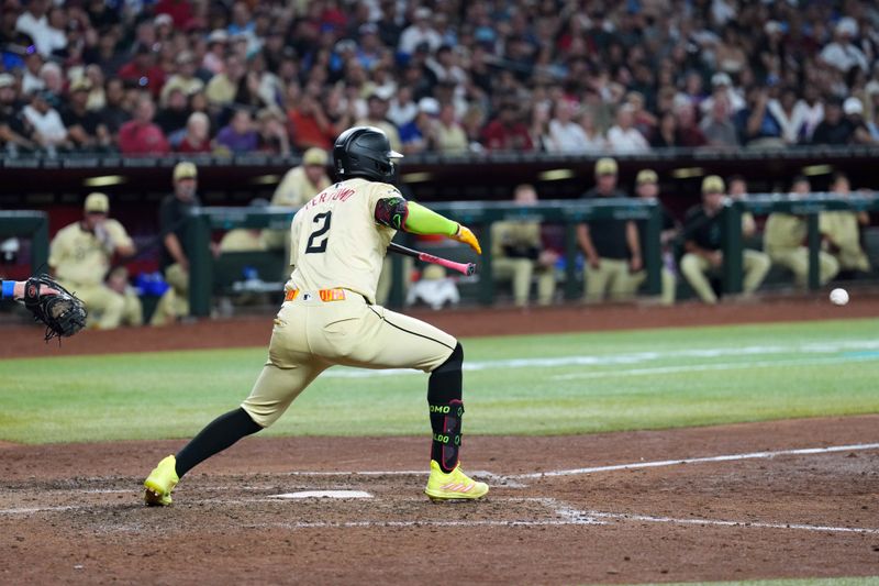 Aug 31, 2024; Phoenix, Arizona, USA; Arizona Diamondbacks shortstop Geraldo Perdomo (2) lays down a sarifce bunt against the Los Angeles Dodgers during the seventh inning at Chase Field. Mandatory Credit: Joe Camporeale-USA TODAY Sports