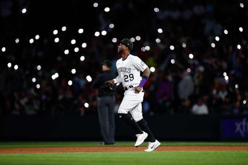 May 26, 2023; Denver, Colorado, USA; Colorado Rockies left fielder Jurickson Profar (29) runs onto the field in the ninth inning against the New York Mets at Coors Field. Mandatory Credit: Isaiah J. Downing-USA TODAY Sports