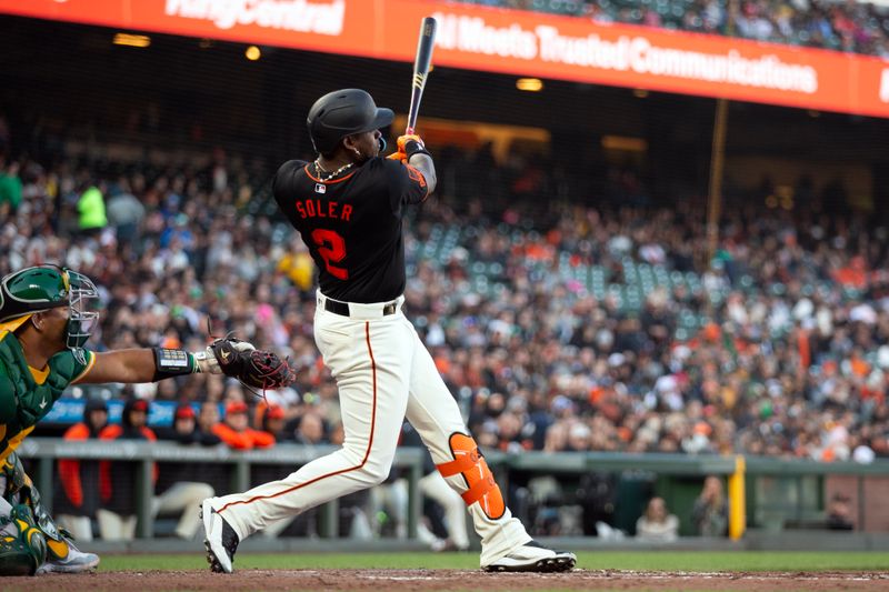 Mar 26, 2024; San Francisco, California, USA; San Francisco Giants designated hitter Jorge Soler (2) follows through on his fly out to center field against the Oakland Athletics during the fourth inning at Oracle Park. Mandatory Credit: D. Ross Cameron-USA TODAY Sports