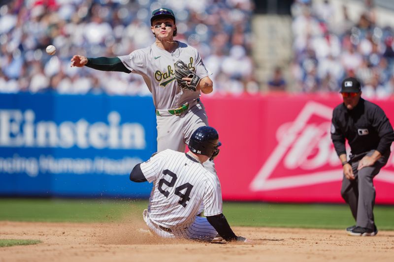 Apr 22, 2024; Bronx, New York, USA; Oakland Athletics second baseman Zack Gelof (20) turns a double play against New York Yankees left fielder Alex Verdugo (24) during the eighth inning at Yankee Stadium. Mandatory Credit: Gregory Fisher-USA TODAY Sports