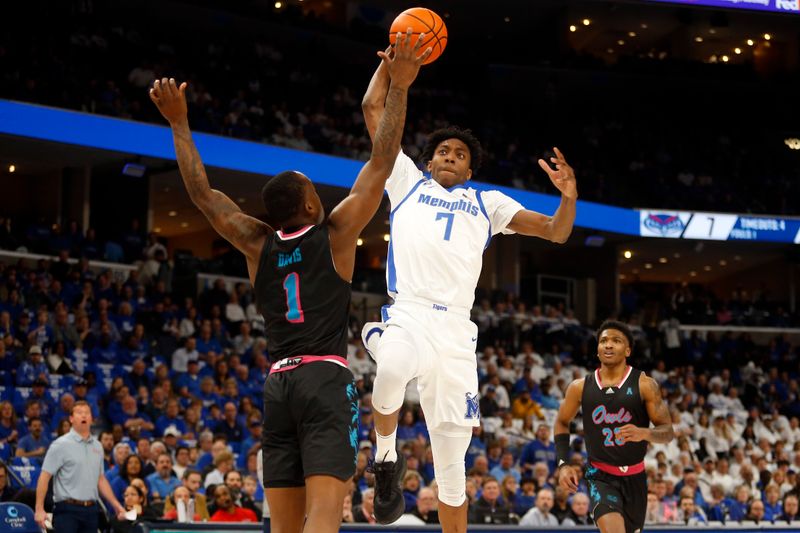 Feb 25, 2024; Memphis, Tennessee, USA; Memphis Tigers forward Nae'Qwan Tomlin (7) drives to the basket as Florida Atlantic Owls guard Johnell Davis (1) defends during the first half at FedExForum. Mandatory Credit: Petre Thomas-USA TODAY Sports