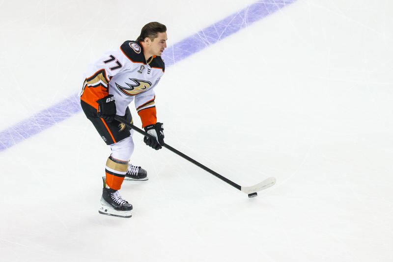 Apr 2, 2024; Calgary, Alberta, CAN; Anaheim Ducks right wing Frank Vatrano (77) skates with the puck during the warmup period against the Calgary Flames at Scotiabank Saddledome. Mandatory Credit: Sergei Belski-USA TODAY Sports