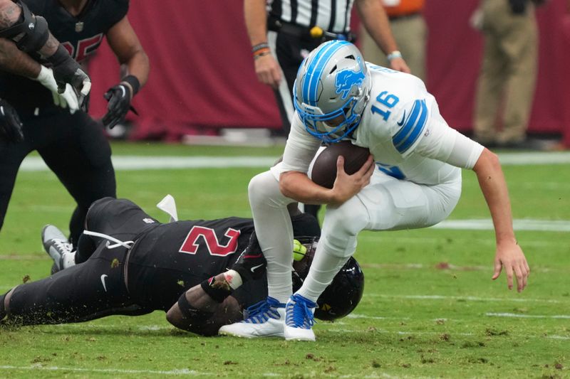 Detroit Lions quarterback Jared Goff (16) is sacked by Arizona Cardinals linebacker Mack Wilson Sr. (2) during the first half of an NFL football game Sunday, Sept. 22, 2024, in Glendale, Ariz. (AP Photo/Rick Scuteri)