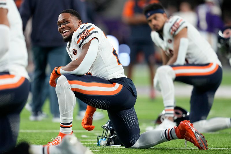 Chicago Bears running back Khalil Herbert (24) stretches before an NFL football game against the Minnesota Vikings, Monday, Nov. 27, 2023, in Minneapolis. (AP Photo/Abbie Parr)