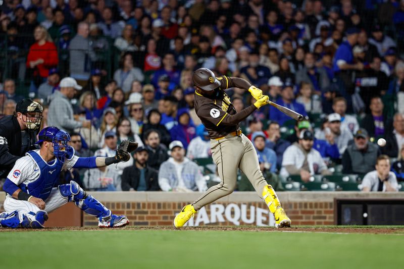 May 6, 2024; Chicago, Illinois, USA; San Diego Padres outfielder Jurickson Profar (10) hits a two-run single against the Chicago Cubs during the sixth inning at Wrigley Field. Mandatory Credit: Kamil Krzaczynski-USA TODAY Sports