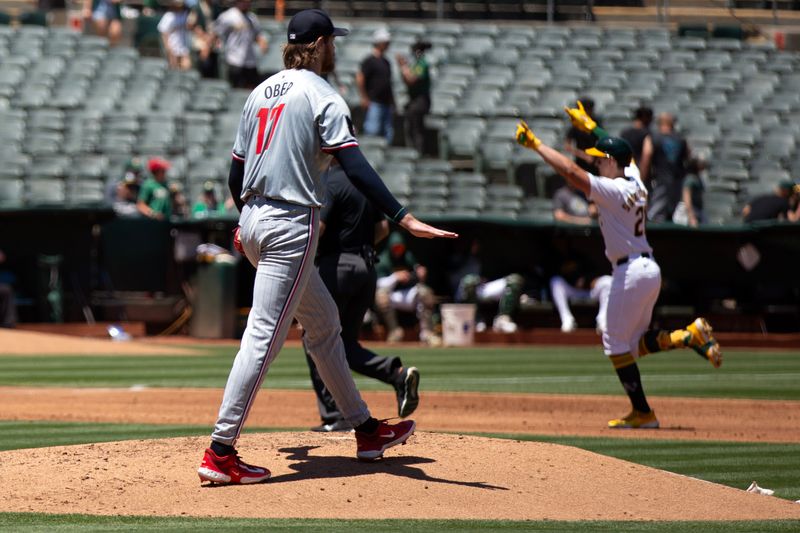 Jun 22, 2024; Oakland, California, USA; Minnesota Twins starting pitcher Bailey Ober (17) watches Oakland Athletics first baseman Tyler Soderstrom (21) run out his solo home run during the second inning at Oakland-Alameda County Coliseum. Mandatory Credit: D. Ross Cameron-USA TODAY Sports
