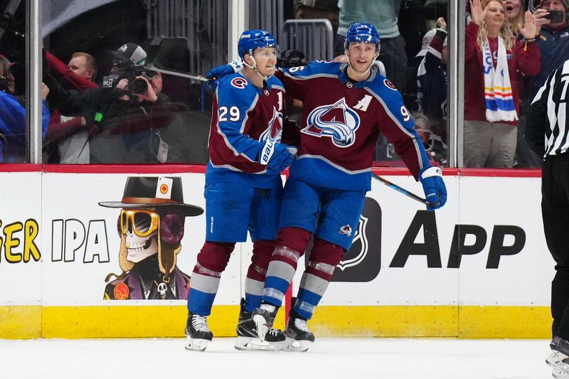 Mar 24, 2024; Denver, Colorado, USA; Colorado Avalanche center Nathan MacKinnon (29) celebrates his third period goal with right wing Mikko Rantanen (96) against the Pittsburgh Penguins at Ball Arena. Mandatory Credit: Ron Chenoy-USA TODAY Sports