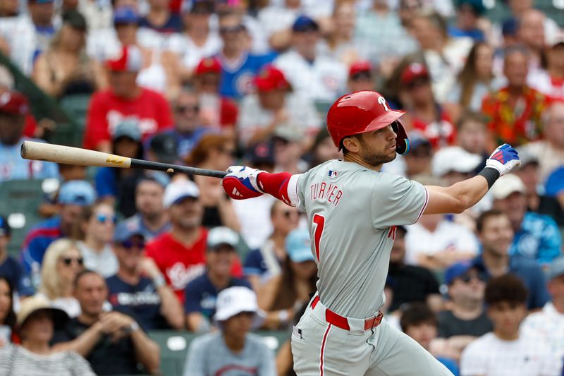 Jul 4, 2024; Chicago, Illinois, USA; Philadelphia Phillies shortstop Trea Turner (7) singles against the Chicago Cubs during the first inning at Wrigley Field. Mandatory Credit: Kamil Krzaczynski-USA TODAY Sports