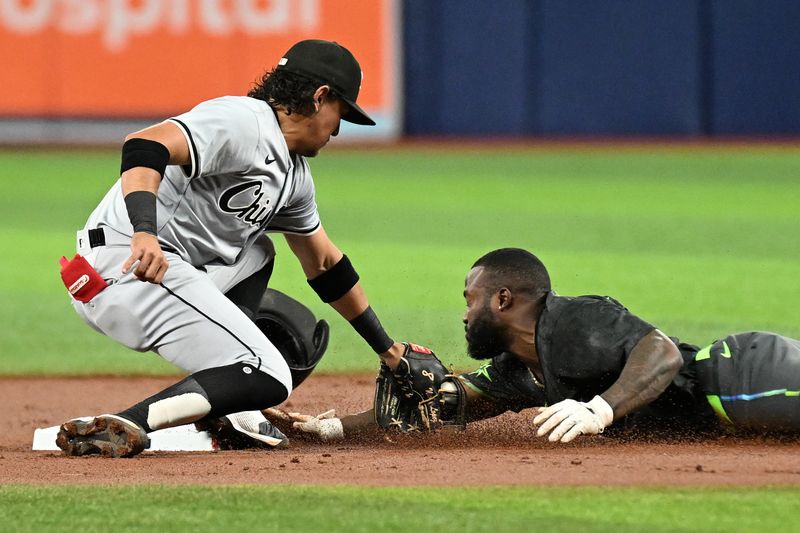 May 7, 2024; St. Petersburg, Florida, USA; Chicago White Sox second baseman Nicky Lopez (8) tags out Tampa Bay Rays left fielder Randy Arozarena (56) in the first inning at Tropicana Field. Mandatory Credit: Jonathan Dyer-USA TODAY Sports