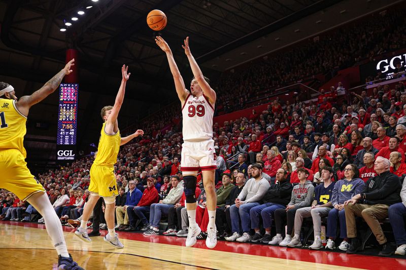 Feb 1, 2025; Piscataway, New Jersey, USA; Rutgers Scarlet Knights center Zach Martini (99) makes a three point basket during the second half against the Michigan Wolverines at Jersey Mike's Arena. Mandatory Credit: Vincent Carchietta-Imagn Images