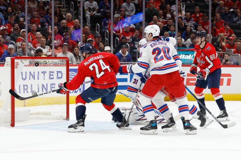 Oct 29, 2024; Washington, District of Columbia, USA; Washington Capitals center Connor McMichael (24) scores a goal on New York Rangers goaltender Igor Shesterkin (31) in the first period at Capital One Arena. Mandatory Credit: Geoff Burke-Imagn Images