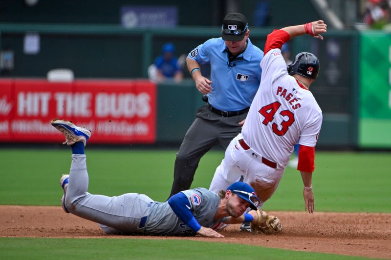 Jul 14, 2024; St. Louis, Missouri, USA;  Chicago Cubs second baseman Nico Hoerner (2) dives to tag out St. Louis Cardinals catcher Pedro Pages (43) during the second inning at Busch Stadium. Mandatory Credit: Jeff Curry-USA TODAY Sports